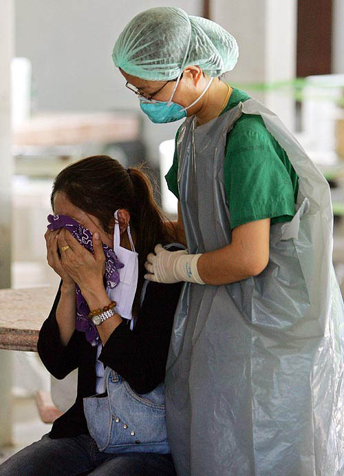 A Thai woman is comforted by a nurse after searching for missing family members amid hundreds of corpses at a temple in Ban Muan, nearly 130 km north of the Thai resort island of Phuket on December 30. One of the most powerful earthquakes in history hit Asia on Sunday, unleashing a tsunami which devastated coastal areas of Sri Lanka, India, Indonesia and tourist isles in Thailand, killing tens of thousands of people.  Reuters