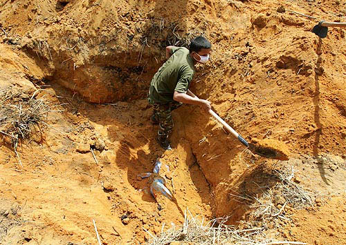 A Thai soldier makes preparations for mass graves in Ban Muan, nearly 130 km north of the Thai resort island of Phuket, on December 30. One of the most powerful earthquakes in history hit Asia on Sunday, unleashing a quake-triggered tidal wave which devastated coastal areas of Sri Lanka, India, Indonesia and tourist isles in Thailand, killing tens of thousands of people.  Reuters
