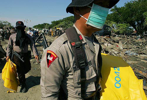 Indonesian soldiers carry body bags that they will use for victims of Sunday's quake-triggered tidal wave in Banda Aceh, Indonesia, on December 30.  Reuters