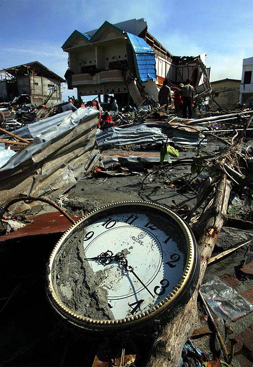 On December 30, a clock rests among debris left behind when a huge tsunami wave hit the town following Sunday's massive earthquake in Banda Aceh, Indonesia.  Reuters