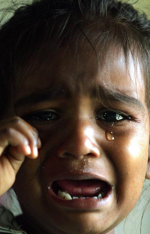 Kamalvathi, 2, a survivor of Sunday's devastating tsunami, cries in a hospital where she was admitted for leg injuries in Cuddalore, about 180 km south of Chennai on December 30. Kamalavathi was alone in her house in Devinampatnam in Cuddalore when the tsunami stuck. Her father, Anbarasan, a fisherman, was at sea and her mother, Kalai Selvi, was in the town. Both parents survived.  Reuters