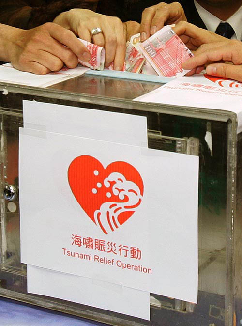 Members from various political parties in Hong Kong donate money during a news conference as they launch a large fund raising campaign for earthquake and tsunami victims of South Asia, on December 30. Organisers have decided to postpone a large anti-government protest in the territory on New Year's Day and instead will hold the fund raising campaign. More than 200 Hong Kong residents are still missing in Thailand and other areas afflicted by the tsunami.  Reuters