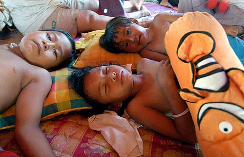 Indonesian children rest in a makeshift refugee camp after the city was devastated by huge tsunami wave which hit following Sunday's massive earthquake in Banda Aceh, on December 30.  Reuters