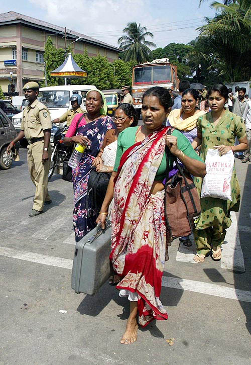 Women walk on the main road after the Indian government issued tsunami alerts for all coastline areas in Port Blair on December 30. The Indian government on Thursday issued tsunami alerts for all areas hit by the weekend's killer waves, prompting panicking people to flee the coastlines.  Reuters