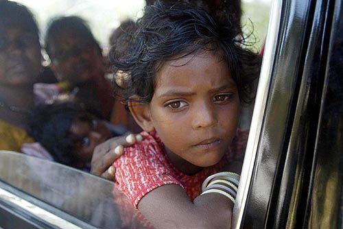Kaushaliya, a ten-year-old girl, travels by taxi with her family to a safe area in Port Blair after the Indian government issued tsunami alerts for all coastline areas on December 30. Reuters