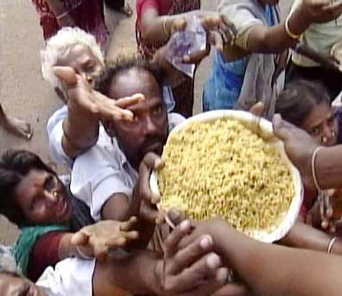 A man eagerly waits for his share of plate in Nagapattinam, one of the worst hit areas of the tsunami disaster in southern Tamil Nadu on December 30. At least 4,000 volunteers are working overtime in Nagapattinam alone to distribute whatever they could before it is too late.  ANI