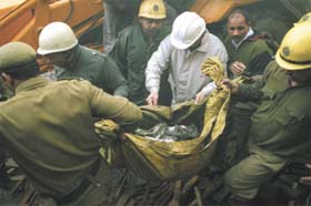 A body of a fireman being carried away at timber market in Kirti Nagar in the Capital