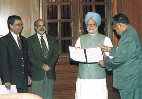 The Minister of State for Heavy Industry and Public Enterprises, Mr Santosh Mohan Dev, presenting a cheque of Rs 1 crore on behalf of Bharat Heavy Electricals Ltd. (BHEL) to Prime Minister Dr Manmohan Singh