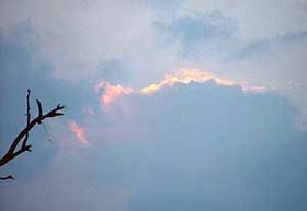 The sun of 2004 sets under clouds with the hope that the new year will bring prosperity and happiness
