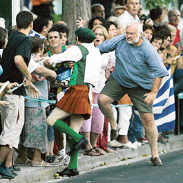 Retired Greek basketball player Polyvios Kossivas (R) stepped in to rescue Brazilian marathon runner Vanderlei de Lima from the clutches of former Irish priest Cornelius Horan during the Athens Olympics.