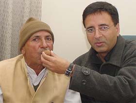 Chaudhary Tek Chand Nen (former minister of Haryana) is offered sweets from Randeep Surjewala, working President, HPCC, after joining the Congress at the Indian Youth Congress office in New Delhi