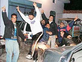 Youths celebrate New Year Eve on the Jalandhar bypass in Ludhiana on Friday. 