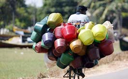 A plastic bucket seller cycles through a tsunami-devastated hamlet in Cuddalore, about 180 km south of Chennai on Sunday.