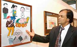 S.C. Bhattacharya with his cartoons displayed at Punjab Kala Bhavan in Sector 16, Chandigarh, on Sunday. 