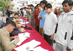 Domestic workers being registered at a police camp in Sector 20, Chandigarh, on Sunday. 