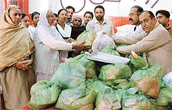 Widows receive ration at a function organised by the Punjab Nishkam Sewa Dal on Sunday.