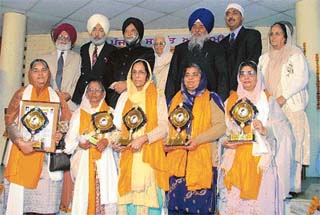 Awardees of Puran Singh Dhami Award with guests at Punjabi Bhavan on Sunday.
