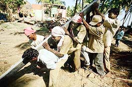 Workers install a lamp post in Cuddalore, about 180 km south of Chennai, 