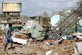 A man walks past debris  near Nagapattinam beach, 350 km south of Chennai, on Sunday. 
