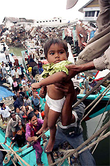 Acehnese refugees from Aceh island arrive by boat to the city of Banda Aceh on Sunday in search of food and shelter after last weeks quake-triggered tidal wave devastated the area on the northern part of the Indonesian island of Sumatra
