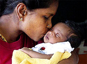 Annal Mary kisses her 20-day-old baby Suppiah Tulasi, who survived the weekend tsunamis