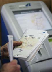 A truck driver studies the "Maut" road map in front of the vending machine of Germanys satellite-based motorway truck toll system Maut at the Swiss-German-border in Weil am Rhein on Monday. Germany started its new road-tolling system on January 1 after clearance for a long-delayed toll system the government hopes it will bring in 2.4 billion euros ($3.2 billion) per year. 