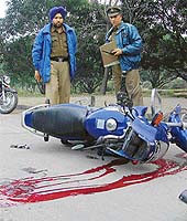 Policemen inspect the site of the accident, in which a youth was killed in Chandigarh on Monday.