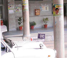 The Deputy Commissioners official car parked under the poster of the Indian National Lok Dal at the Mini Secretariat in Panchkula on Monday