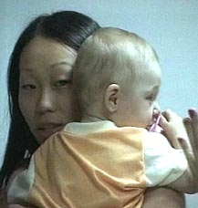 Television image released by a Thai news agency on Sunday shows a Thai woman carrying an 18-month-old Kazakh boy who was found alive in Khao Lak on Saturday almost a week after a tsunami devastated Indian Ocean shores and killed 1,29,817 people. 