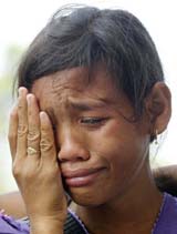 An Acehnese child cries after she did not find information about her parents