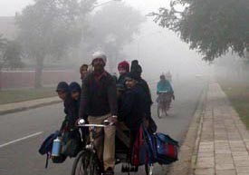 Schoolchildren brave the cold on the way to school in Sector 26 on Wednesday