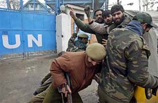 Kashmiri activists from the Muslim League raise slogans after they were detained by the police during a protest in Srinagar