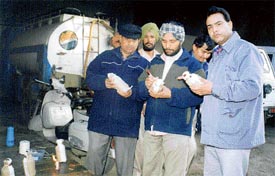 Officials of the Health Department with samples of milk