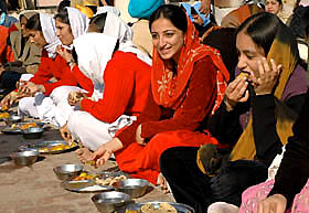 Devotees partake langar on the occasion of the birth anniversary of Guru Gobind Singh at Gurdwara Model Town in Jalandhar on Wednesday.