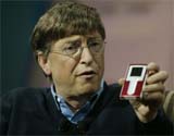 Bill Gates of Microsoft holds an Iriver music player