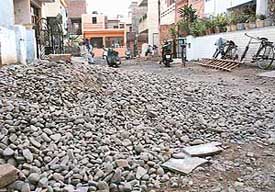 Stones and gravel spread all over the road in Sector 15, Panchkula, making it difficult for commuters to use it.