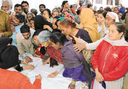 Patients at a medical camp held at the Bapu Dham Colony police post in Sector 26, Chandigarh, on Thursday.