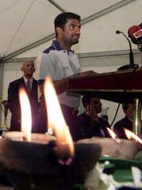 Sri Lankan offspinner Muttiah Muralitharan speaks at a fund raising campaign in Colombo