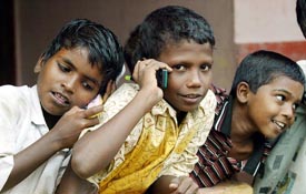 Young tsunami survivors, who lost their parents in the disaster, play with toy mobile phones at a newly opened orphanage on the outskirts of Nagapattinam, 350 km south of Chennai, on Saturday. 