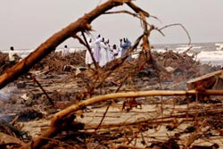 Nuns walk past a bonfire at a fishing hamlet in Velankanni, Tamil Nadu, on Saturday