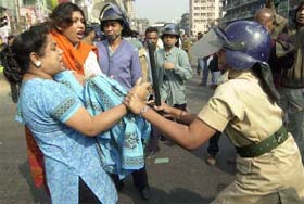 Supporters of main opposition party Awami League tussle with a police officer during an anti-government strike in Dhaka, Bangladesh