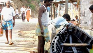 Fishermen repair their boats in Port Blair on Sunday.