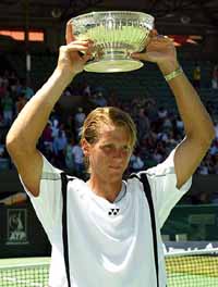 Joachim Johansson of Sweden holds aloft the trophy after defeating Taylor Dent of USA in the final of the Australian mens hardcourt tennis championship