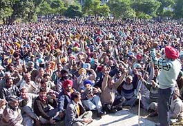 Employees of Ranjit Sagar Dam hold a protest rally outside the treasury office in Shahpur Kandi on Monday.