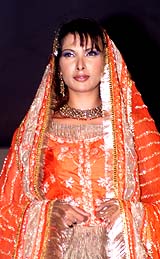 A model displays a bridal outfit designed by Pooja Verma during a fashion show in Lucknow 