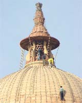 Workers fix lights atop a North Block dome for the annual Republic Day ceremony in New Delhi on Tuesday. 