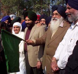 Mr Darshan Singh Dhaliwal (centre), who requisitioned a goods train to take relief material for tsunami victims, seen with SAD President Parkash Singh Badal, who flagged off the relief material at Rakhra village in Patiala.