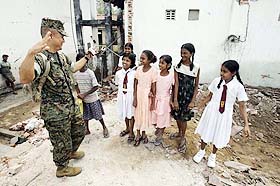 US Marine Captain Danny Chung talks  with Sri Lankan students at Sudarma College, near Galle, in southern Sri Lanka, on Tuesday. Marines landed in the country to assist in relief and reconstruction operations after tsunami disaster.