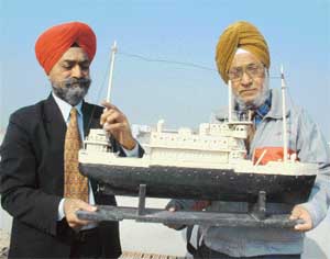 Burmese Sikhs Prof Mohan Singh and Balwinder Singh Aden with the model of a ship made by Japanese POWs.