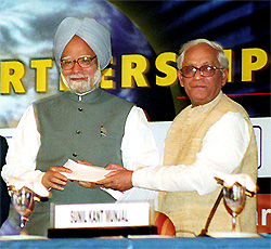 West Bengal Chief Minister Buddhadeb Bhattacharya hands over a cheque for Rs 3.5 crore to Prime Minister Manmohan Singh towards the tsunami relief fund